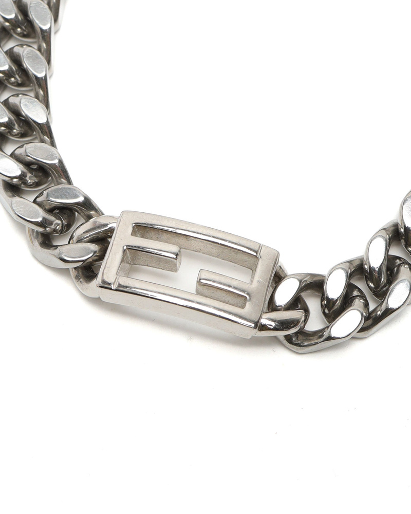 Close-up of the silver-tone FF logo detail on the vintage Fendi Baguette chain bracelet.