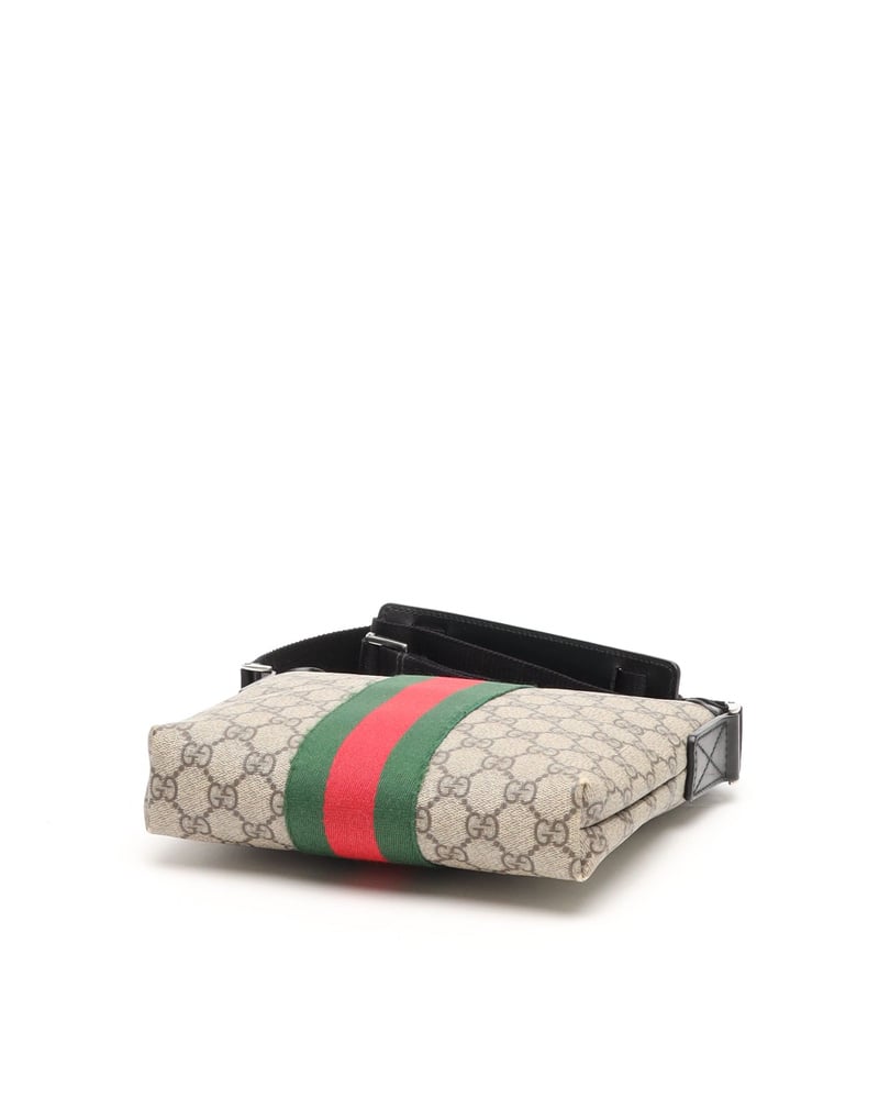 Bottom view of the vintage Gucci Messenger Bag in GG Supreme canvas, showing the iconic green and red Web stripe.