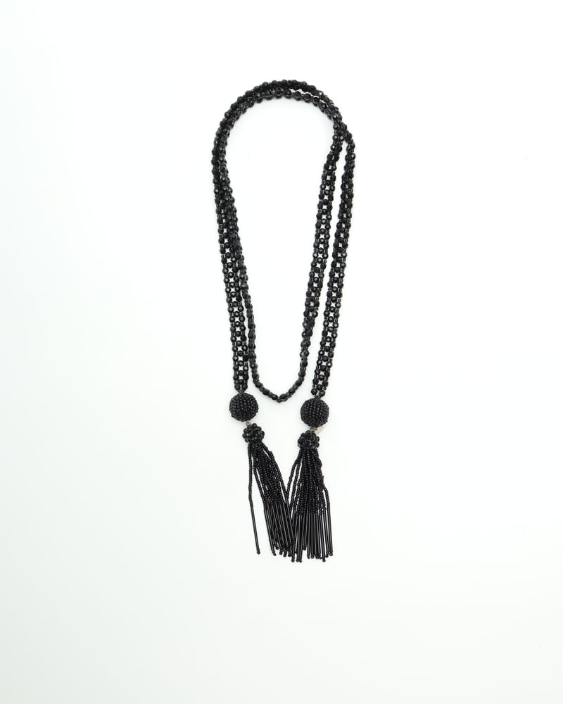 Vintage Bottega Veneta Tassel Necklace in black. Full view of the beaded lariat style with two tassels on a white background.