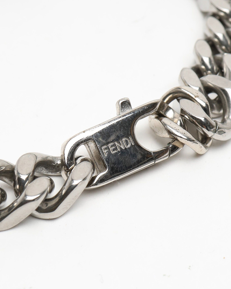 Close-up of the vintage Fendi Baguette Bracelet, showing the silver-toned chunky chain and Fendi engraved logo on the clasp.
